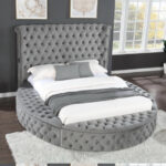An upholstered gray four-piece bedroom set