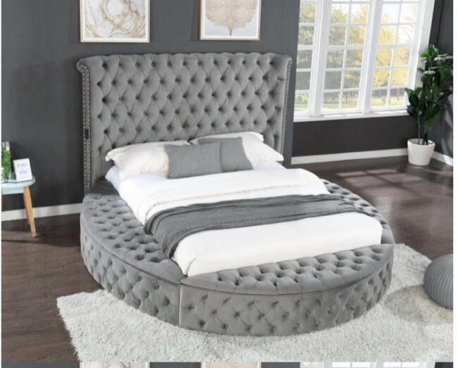 An upholstered gray four-piece bedroom set